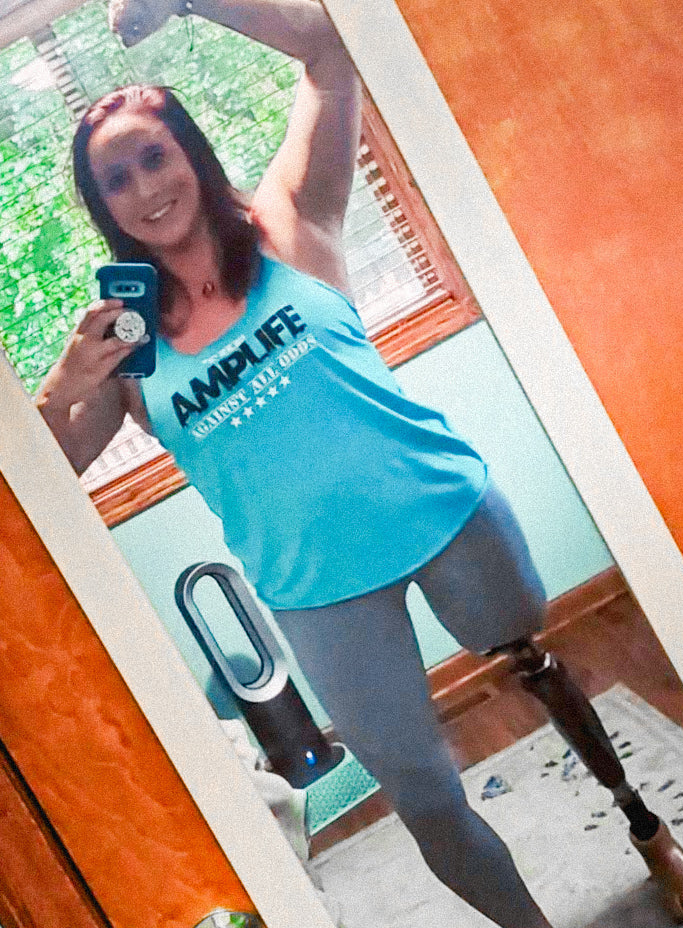 Mirror selfie of Team Amplife® Ambassadors Kara Wolter wearing the Amplife® Against All Odds Tank Top
