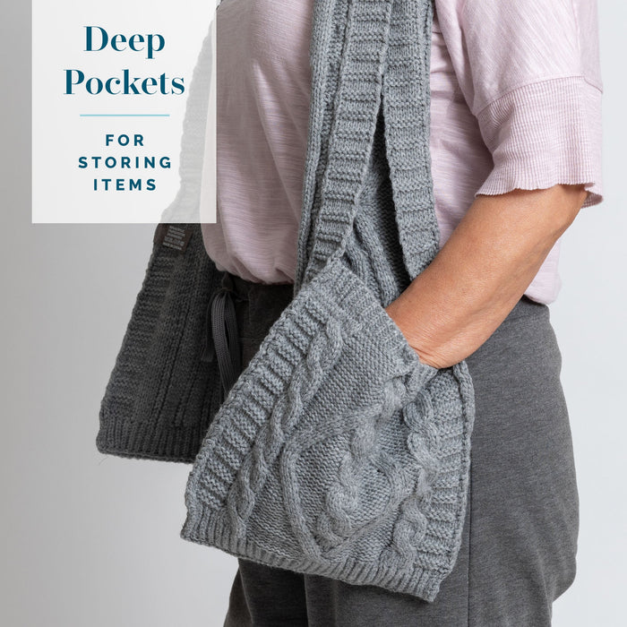 Detail of person placing their hands in the KickIt Infusion & Chemotherapy Knit Scarf with Pockets on a white background. Deep pockets for storing items
