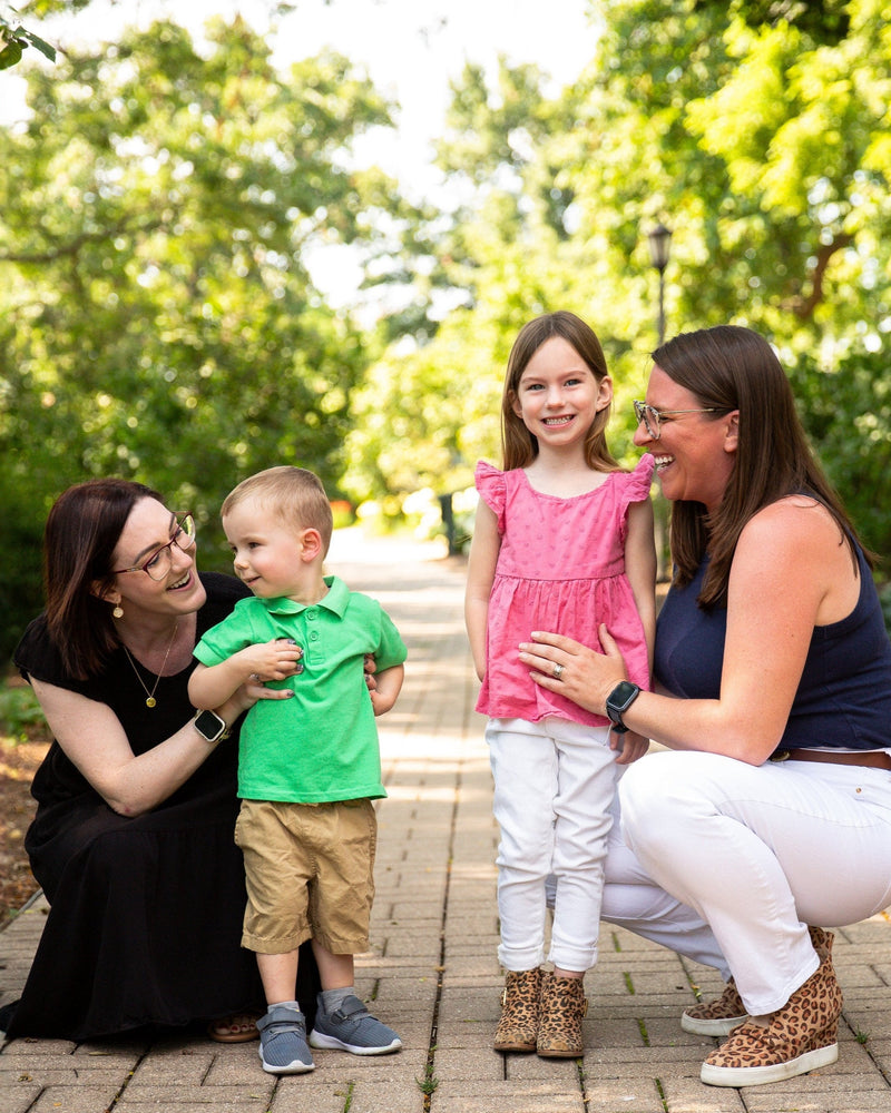Ali Barnum and Kari Treat and their kids in a garden.