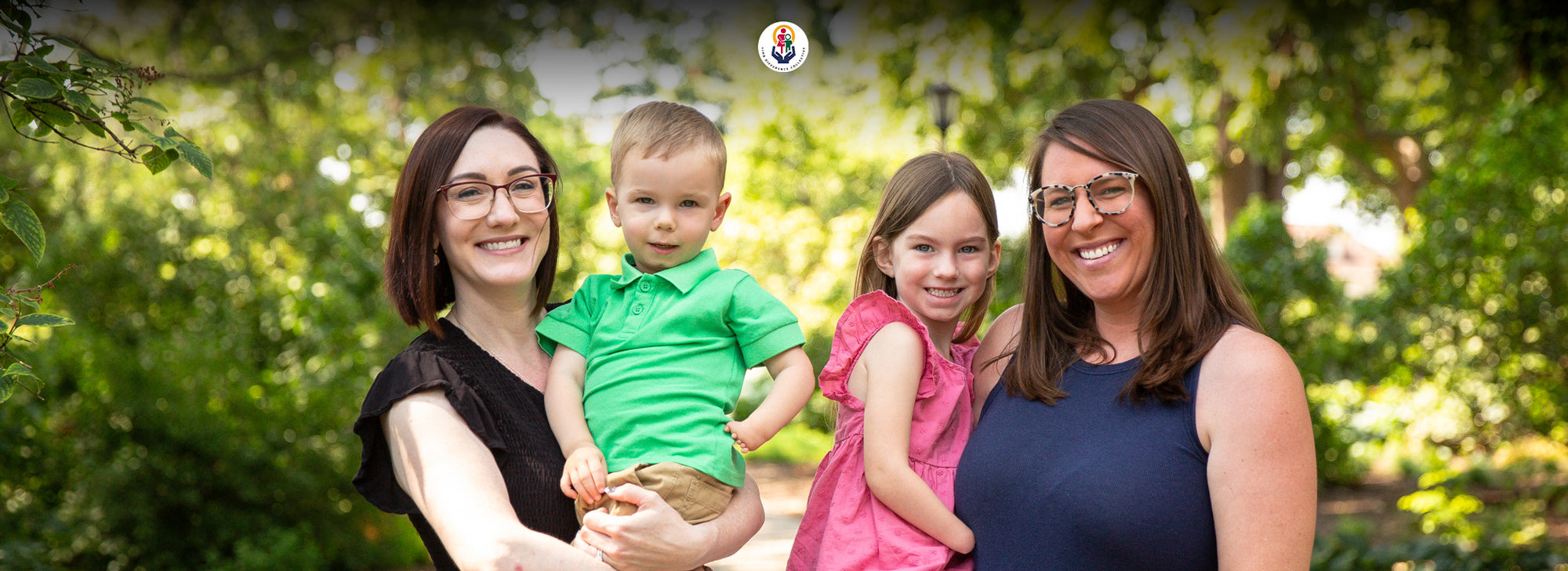Group portrait of Ali Barnum, Kari Treat and their kids in a garden.