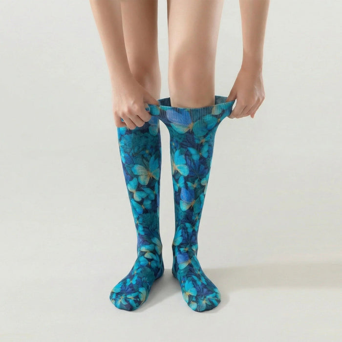 Lairos Blue Flutter Youth / Women's AFO Socks worn on model as they stretch the collar on a white background