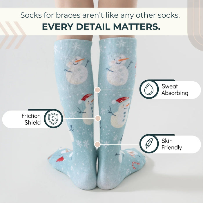 Lairos Frosted Snowman Kids' AFO Socks back worn on model on a white background. Text on image: Socks for braces aren't like any other socks. Every detail matters. Sweat Absorbing. Friction Shield. Skin Friendly.
