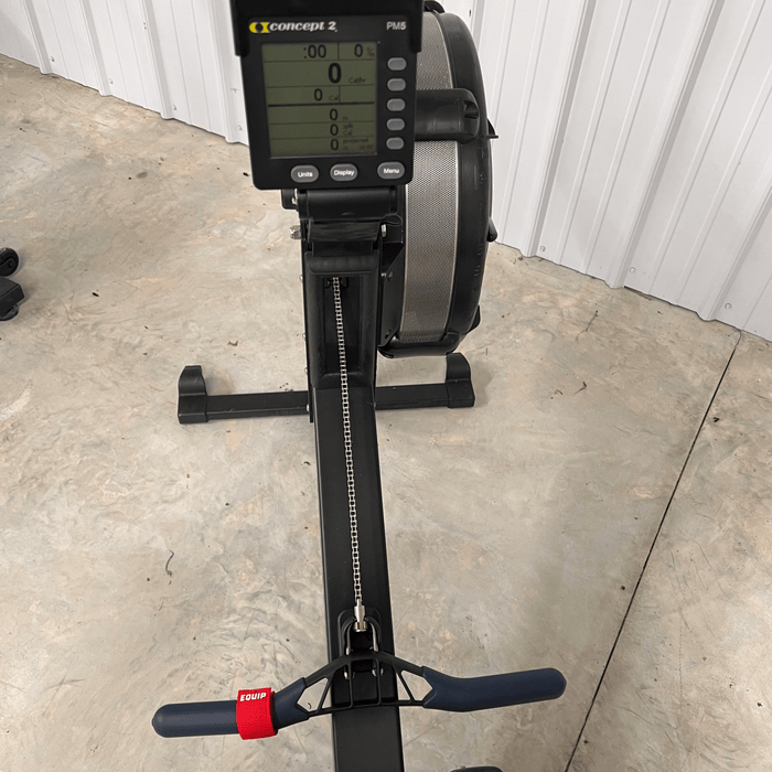 Equip Products Left Neglect Red Straps attached to a Concept2 rowing bar.