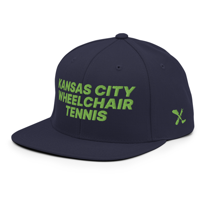 Front left angle of the MAS Kansas City Advantage Wheelchair Tennis Navy Flat Bill Snapback against a white background