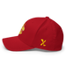 Left side angle of the MAS Kansas City Wheelchair Football Warp Red & Gold Flexfit Curved Bill Fitted against a white background