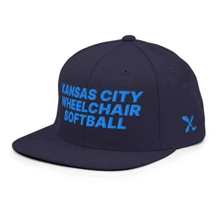 Front left angle of the MAS Kansas City Wheelchair Softball Navy Flat Bill Snapback against a white background