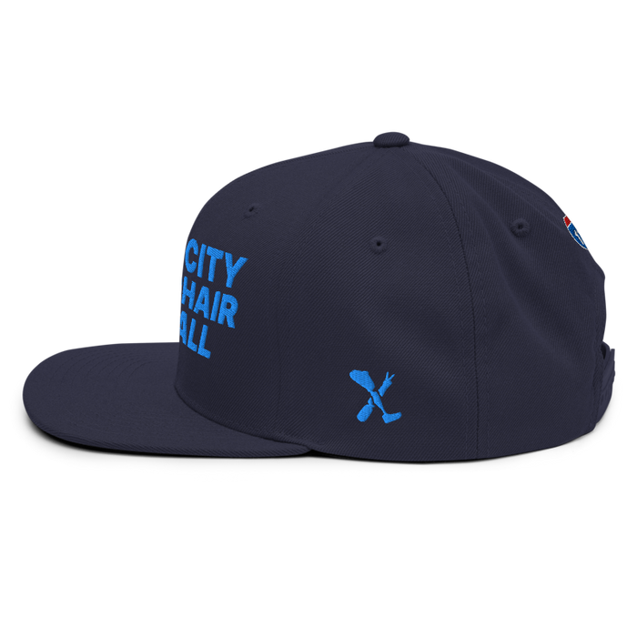 Left angle of the MAS Kansas City Wheelchair Softball Navy Flat Bill Snapback against a white background