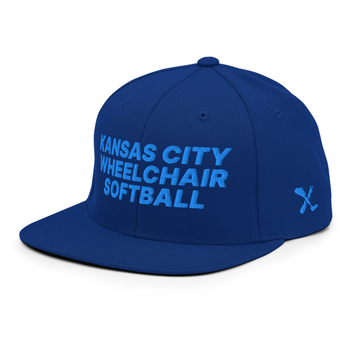 Front left angle of the MAS Kansas City Wheelchair Softball Royal Blue Flat Bill Snapback against a white background
