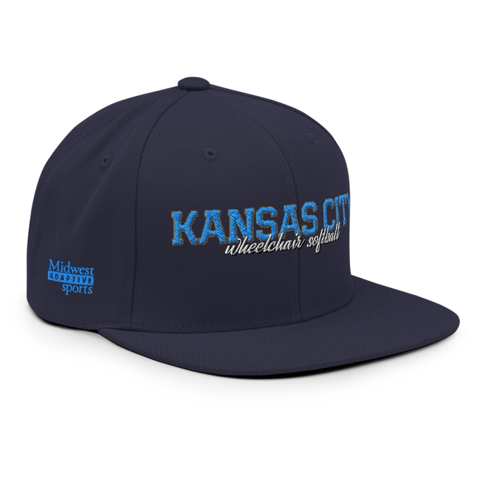 Front right angle of the MAS Kansas City Wheelchair Softball Script Navy Flat Bill Snapback against a white background