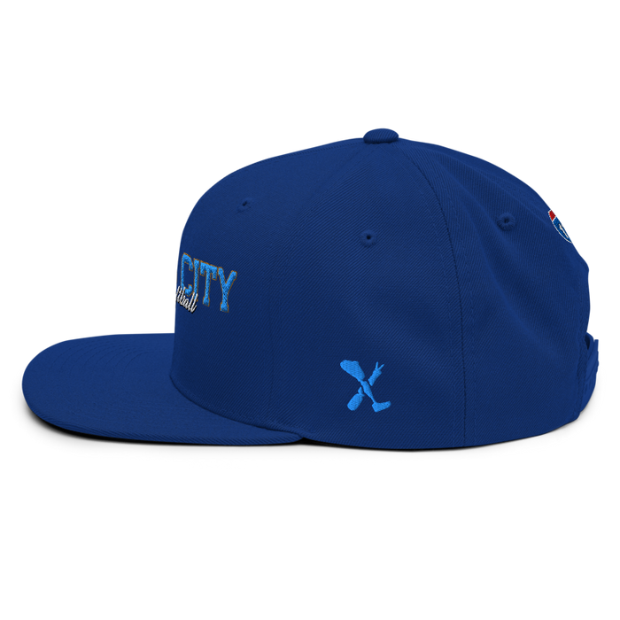 Left angle of the MAS Kansas City Wheelchair Softball Script Royal Blue Flat Bill Snapback against a white background