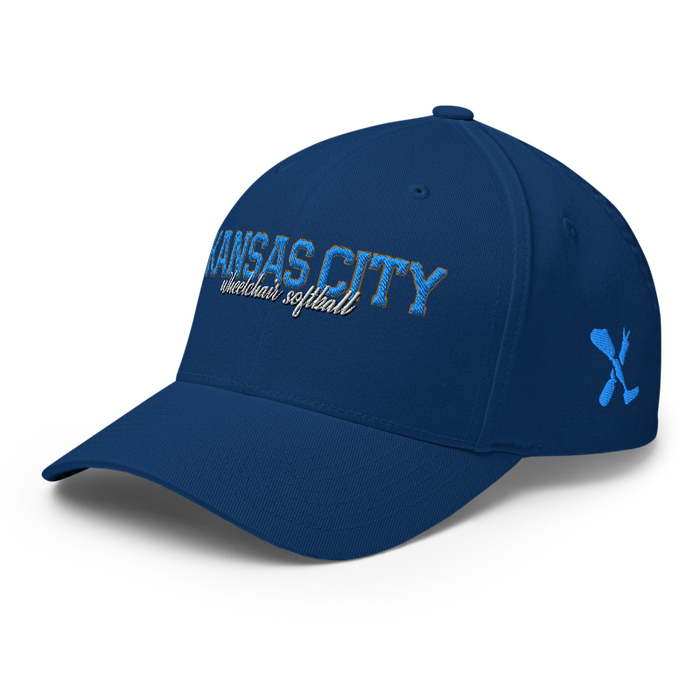 Front left angle of the MAS Kansas City Wheelchair Softball Script Royal Blue Flexfit Curved Bill Fitted against a white background