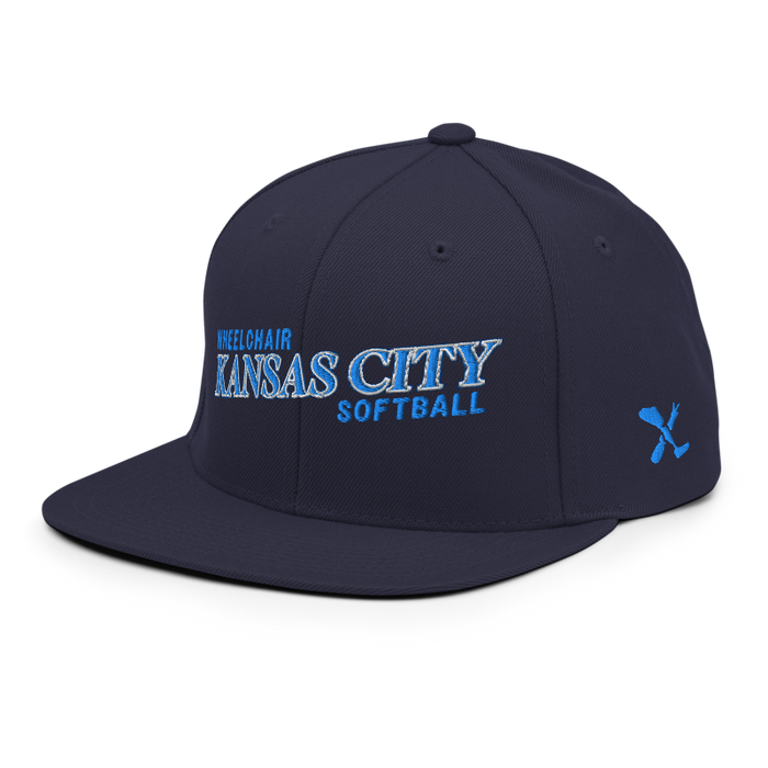 Front left angle of the MAS Kansas City Wheelchair Softball Slant Navy Flat Bill Snapback against a white background