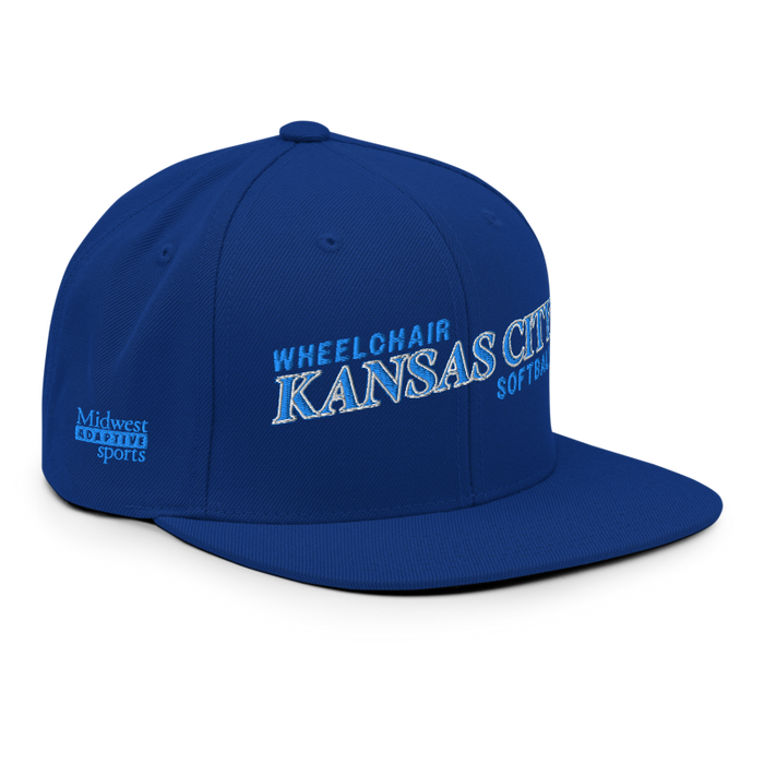 Front right angle of the MAS Kansas City Wheelchair Softball Slant Royal Blue Flat Bill Snapback against a white background