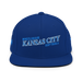 Front angle of the MAS Kansas City Wheelchair Softball Slant Royal Blue Flat Bill Snapback against a white background