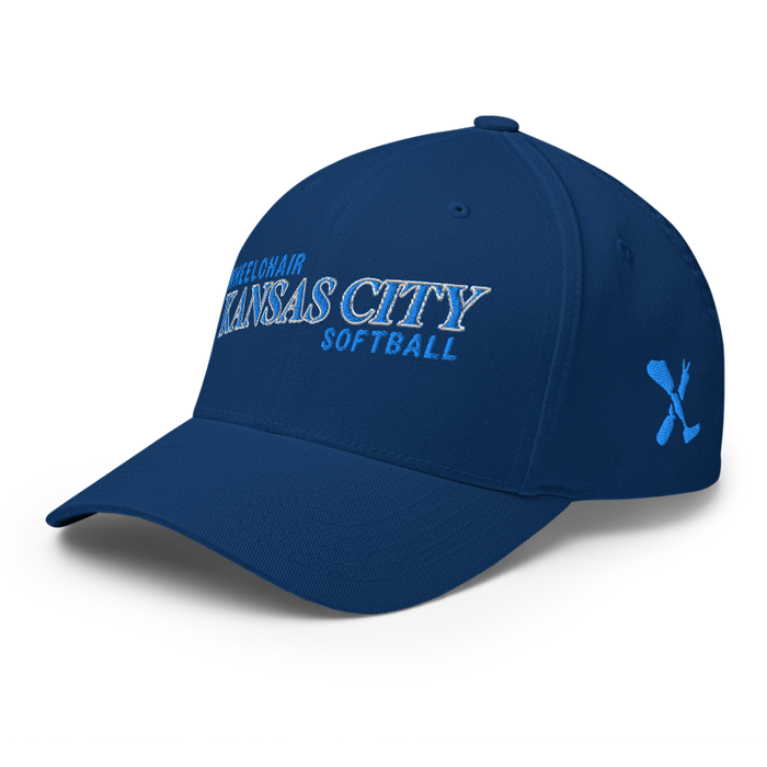 Front left angle of the MAS Kansas City Wheelchair Softball Slant Royal Blue Flexfit Curved Bill Fitted against a white background