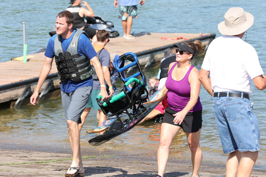 MAS Day at the Lake volunteers carrying an adaptive water ski out of the water at Smithville Lake