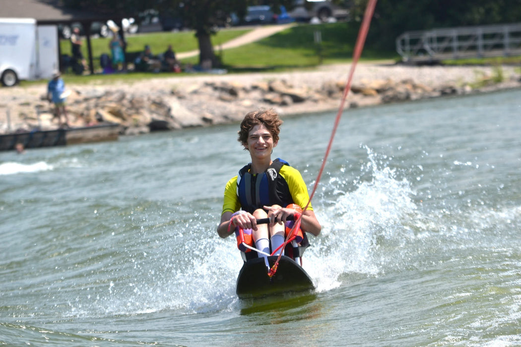 MAS Day at the Lake participant enjoying water skiing while being pulled from a boat at Smithville Lake