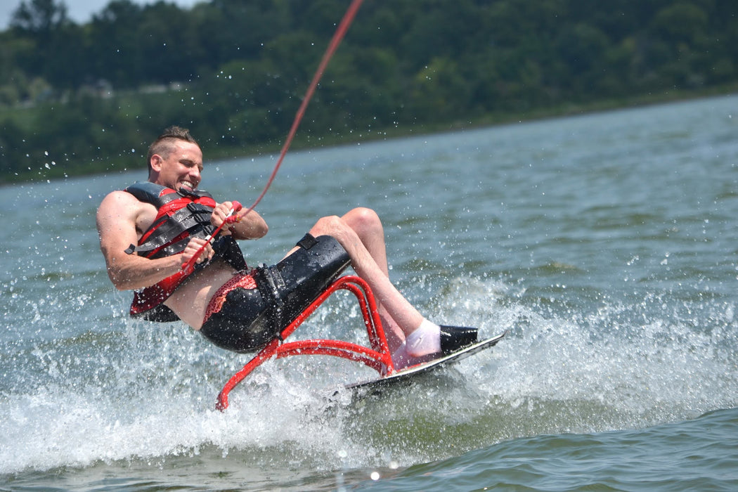 MAS Day at the Lake participant water skiing and riding wake at Smithville Lake during the annual adaptive watersports clinic