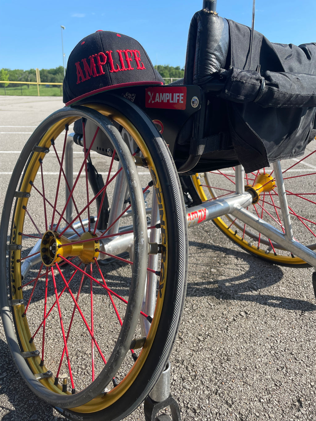 MAS Kansas City Chiefs defender and Team Amplife® Ambassador Jason Loftiss' football wheelchair with the Amplife® Flat Bill Snapback on his wheelchair and Amplife® logo sticker on the side of his wheelchair