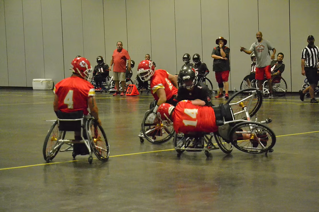 MAS Kansas City Chief's defender fights for ball as he falls over in his wheelchair