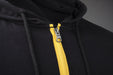 MagZip Adaptive Lightweight Hoodie with Magnetic Zipper arm logo zipper detail on a dark grey background