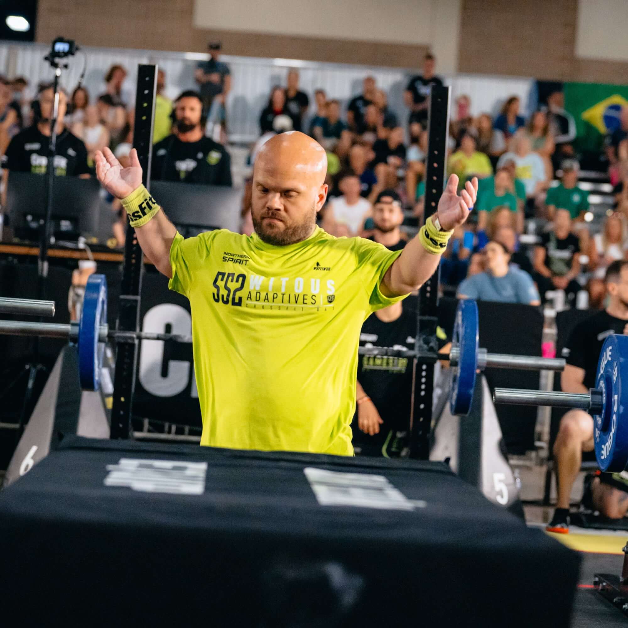 Equip Products The Coffin Tire Flipping about to be flipped by an athlete with short stature in a competition.