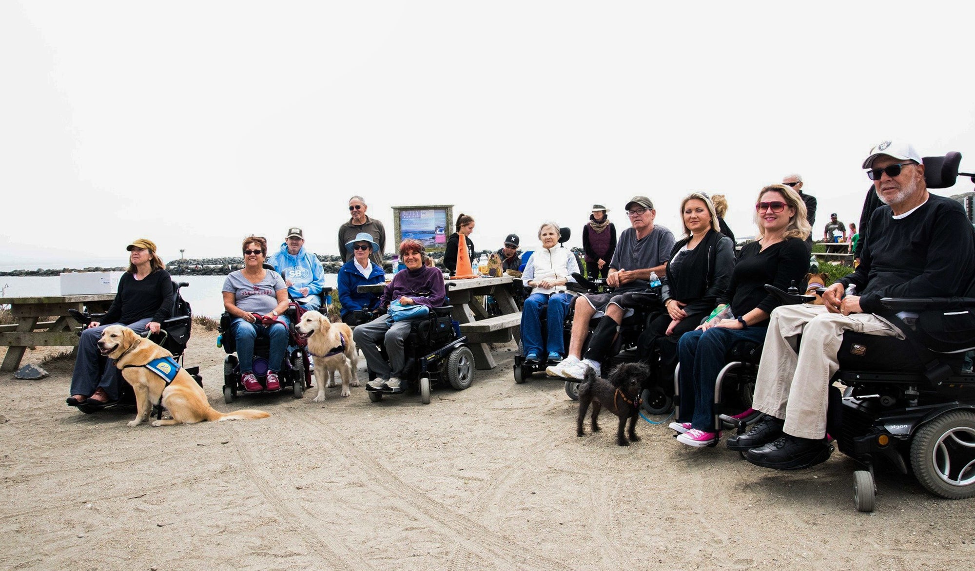Group portrait of NorCal SCI Sonoma Marin Support Group at a park along the water.