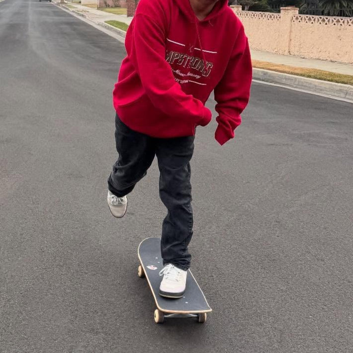 Oscar Loreto Jr skateboarding while wearing the Ampstrong Hoodie.