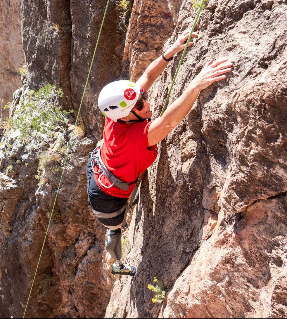 Paradox Sports climber ascending a rocky cliff face