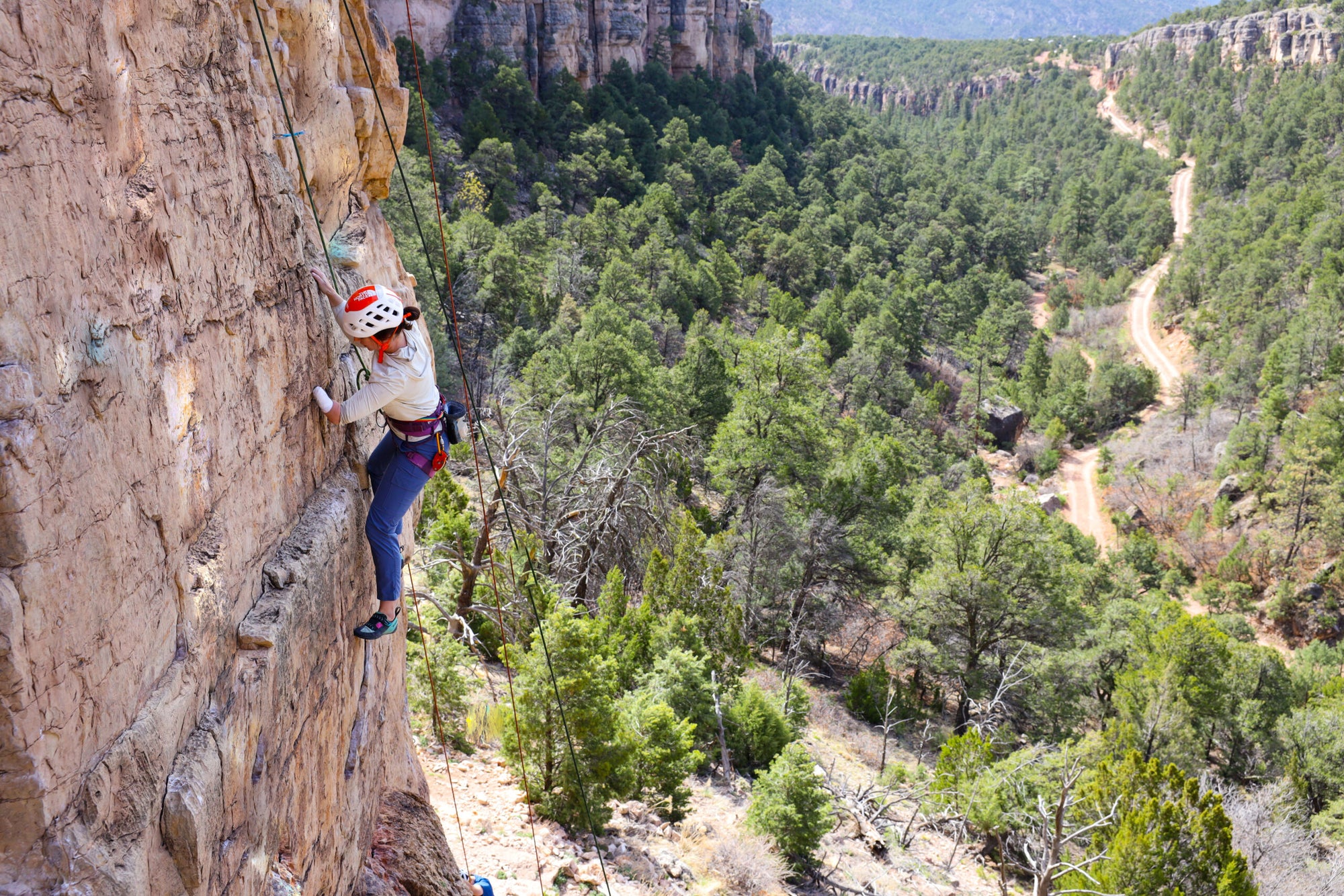 Paradox Sports climber ascending a rock wall at Shelf Road.