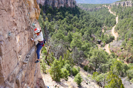 Paradox Sports climber ascending a rock wall at Shelf Road.