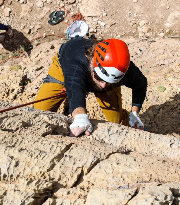 Person in climbing gear on a rocky surface