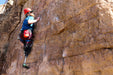 Person with a prosthetic leg climbing a rocky cliff