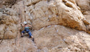 Person rock climbing on a large rocky wall