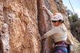 Person rock climbing on a rocky cliff face