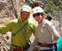Two climbers posing for a photo with climbing gear in a natural outdoor setting.
