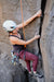 Person rock climbing on a rocky wall.