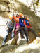 Group of climbers posing on a rocky cliff.