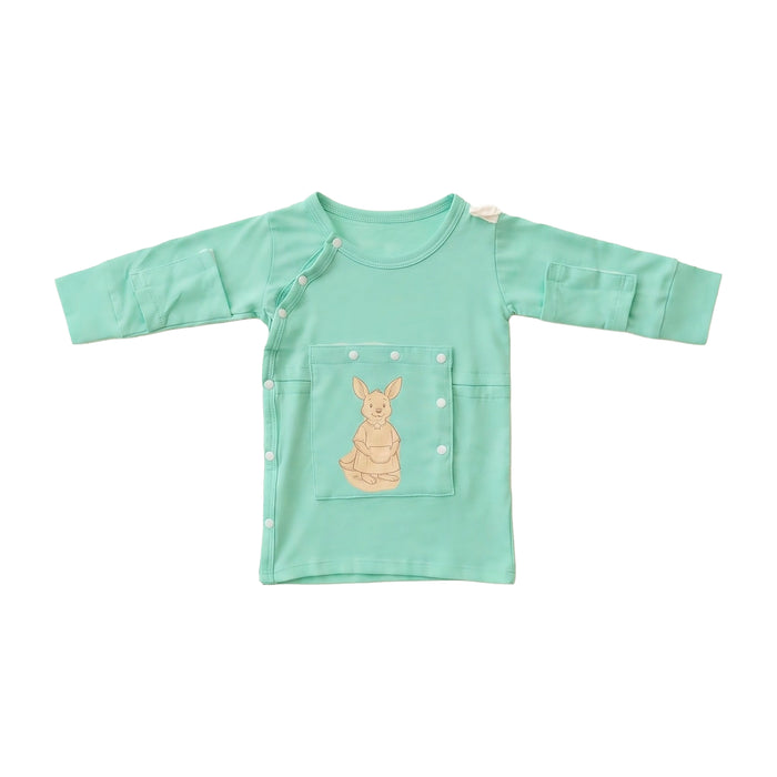 Front angle of the PediaTech Apparel LineWear Central Line Access Baby Gown in mint green (Calm Mint Edition), laid flat with the kangaroo chest pocket snapped closed against a white background