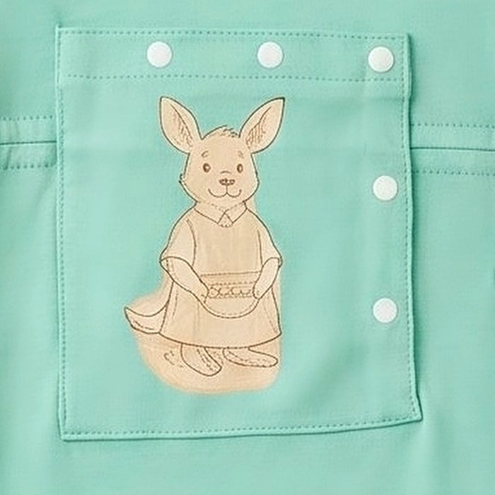 Close-up of the snap-closed chest pocket on the PediaTech Apparel LineWear Central Line Access Baby & Toddler Bodysuit in mint green (Calm Mint Edition), printed with an illustrated kangaroo in a dress holding a basket