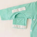 Close-up of a sleeve on the PediaTech Apparel LineWear Central Line Access Baby & Toddler Bodysuit in mint green (Calm Mint Edition) with the arm-access opening along the inner seam unsnapped and its flap folded down