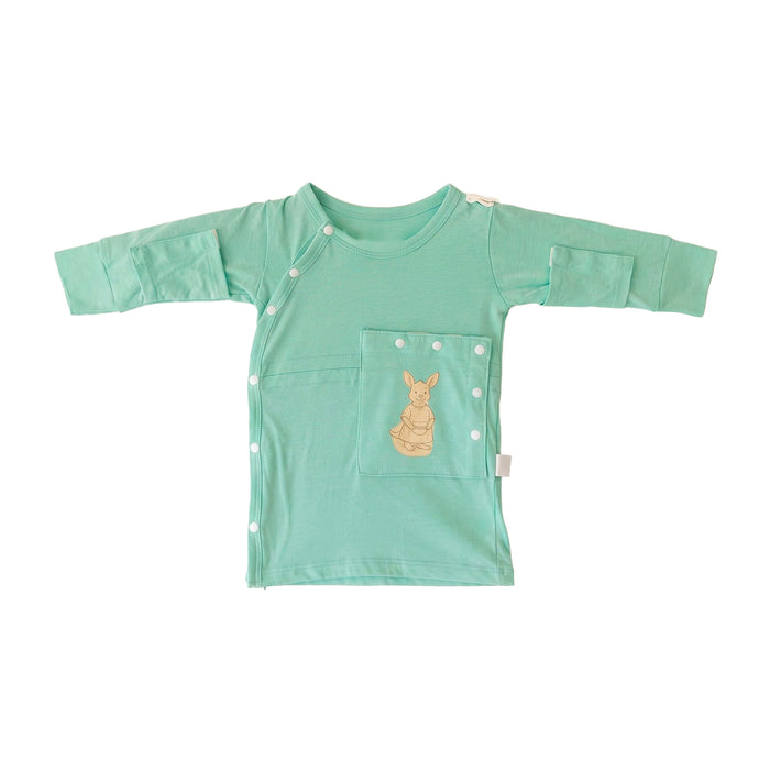 Front angle of the PediaTech Apparel TubeWear G/J Tube Access Baby Gown in mint green (Calm Mint Edition), laid flat with the kangaroo pocket over the abdomen snapped closed against a white background