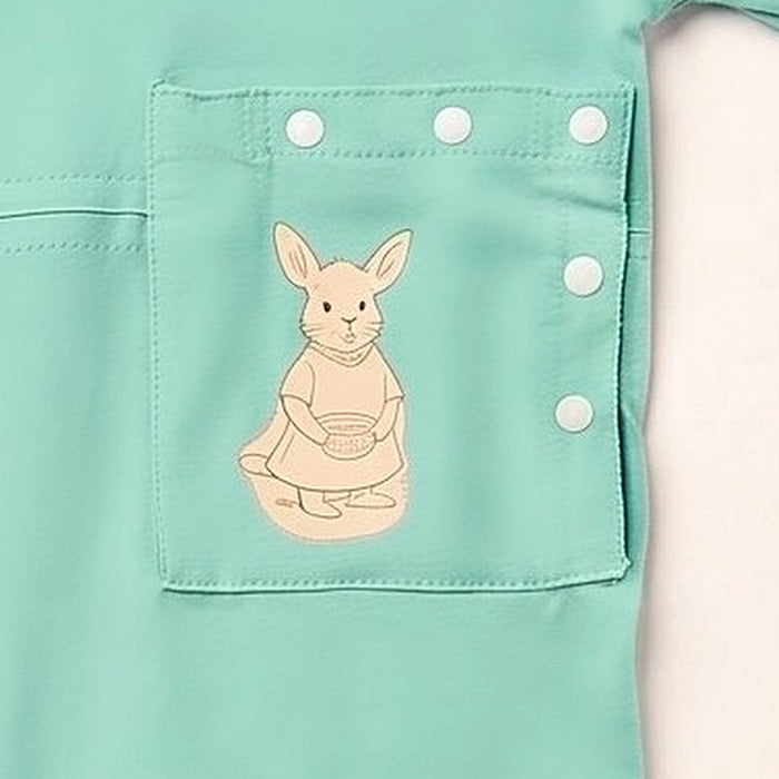 Close-up of the snap-closed pocket over the abdomen on the PediaTech Apparel TubeWear G/J Tube Access Baby & Toddler Bodysuit in mint green (Calm Mint Edition), printed with an illustrated kangaroo in a dress holding a basket