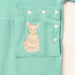 Close-up of the snap-closed pocket over the abdomen on the PediaTech Apparel TubeWear G/J Tube Access Baby & Toddler Bodysuit in mint green (Calm Mint Edition), printed with an illustrated kangaroo in a dress holding a basket