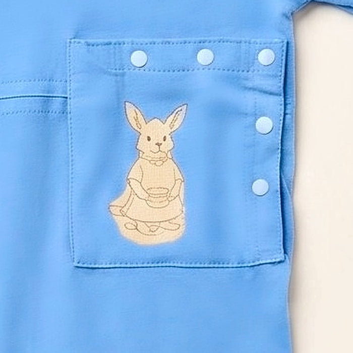 Close-up of the snap-closed pocket over the abdomen on the PediaTech Apparel TubeWear G/J Tube Access Baby & Toddler Bodysuit in light blue (Sky Lullaby Edition), printed with an illustrated kangaroo in a dress holding a basket