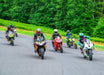 Ride Again Foundation Motorcyclists racing on a road with greenery in the background