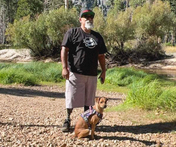 Team Amplife® Ambassador Steven Hill wearing the Death Cheater® Halo T-Shirt standing next to his dog Coa.