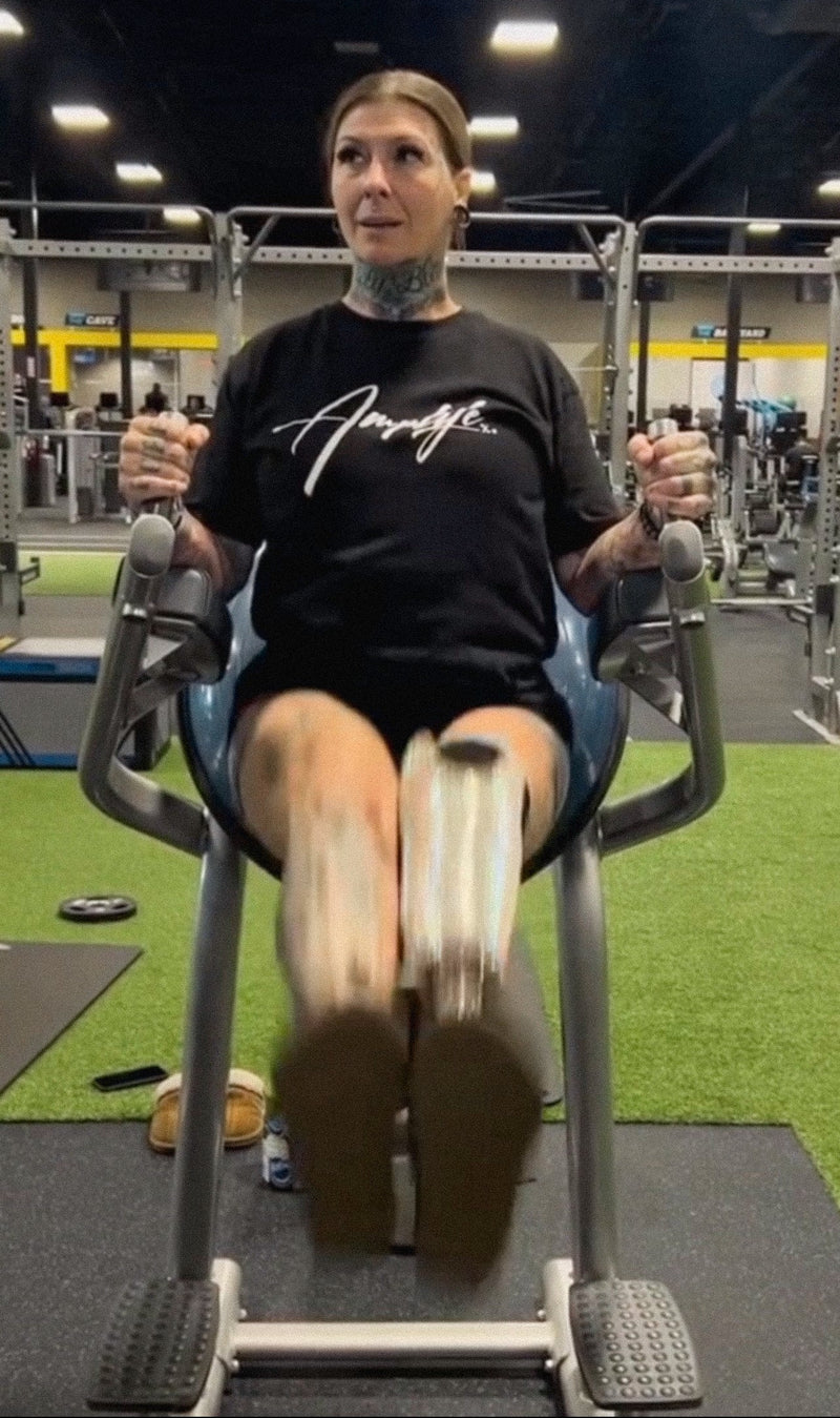 Team Amplife® Ambassador SuZanne Jacobsen wearing the Amplife® Signature while performing leg raises in the gym