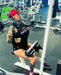 SuZanne Jacobsen performing a lat pulldown while wearing the Severed Society® Drip T-Shirt.