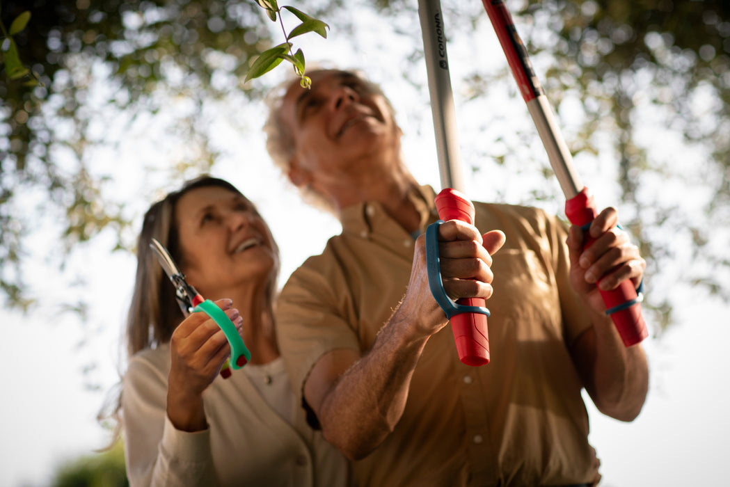 Two people holding gardening shears in a garden setting using EaZyHold products.